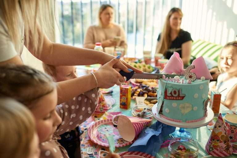 Family gathered around a table with a birthday cake